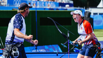 Brady Ellison and Casey Kaufhold celebrating after winning the mixed team bronze